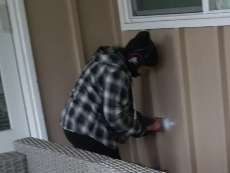 Professional electrician installing an exterior outlet in Bedford